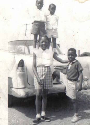 Sisters & bro L-R on top Lavinia, Lissa,Lois and Henny Jr.in front of our dad Henny Chandlers 56 Chevy.  Photo taken in Oyster Bay, L.I. in 62.